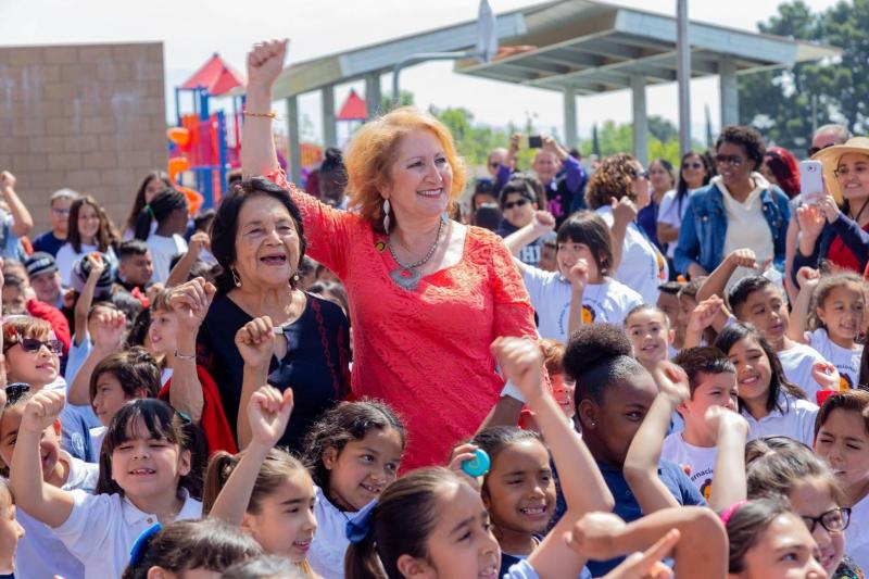 Senator Reyes and Dolores Huerta standing together at a parade