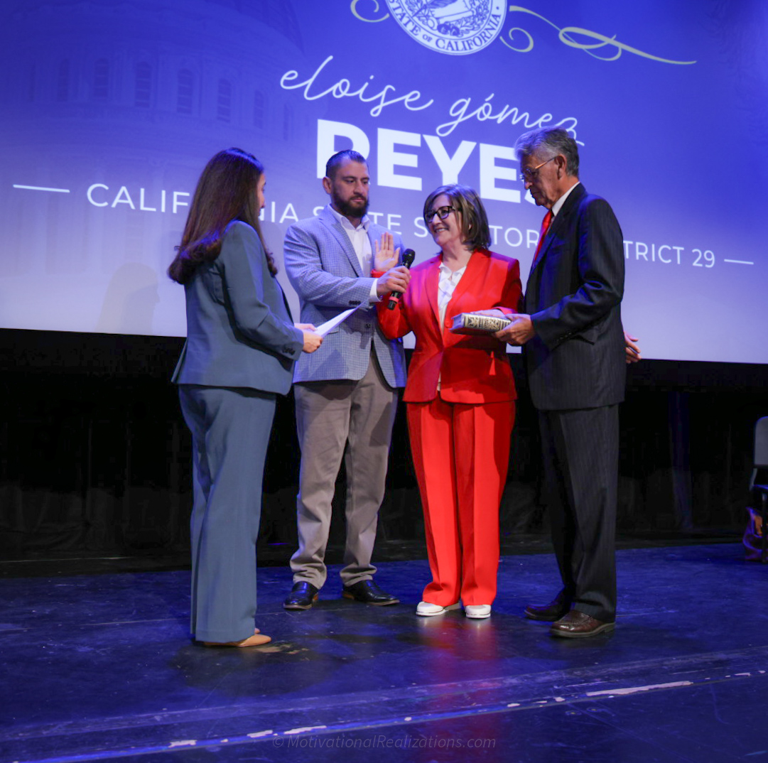 Senator Reyes stands with her husband and son as she is sworn in by Senator Limon