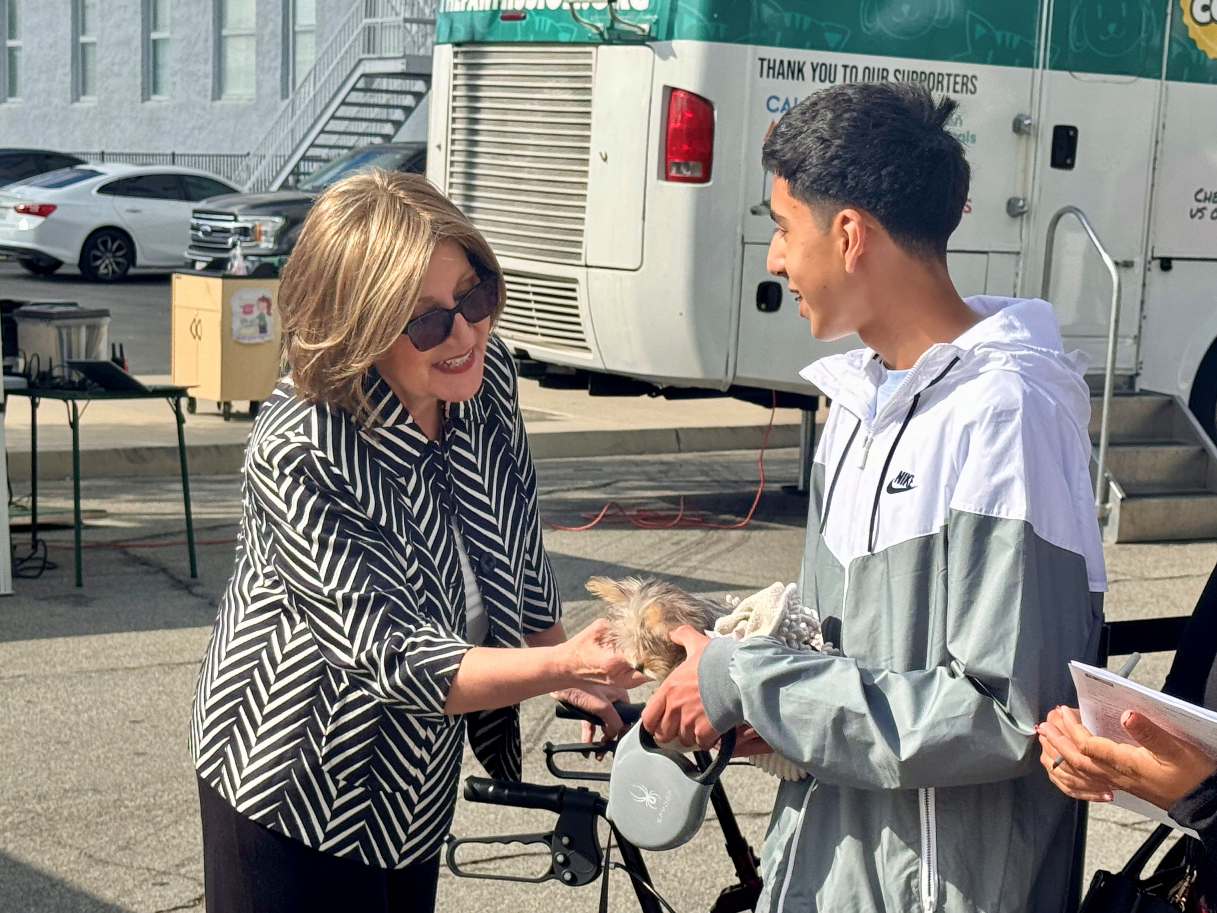 Senator Reyes pets a puppy