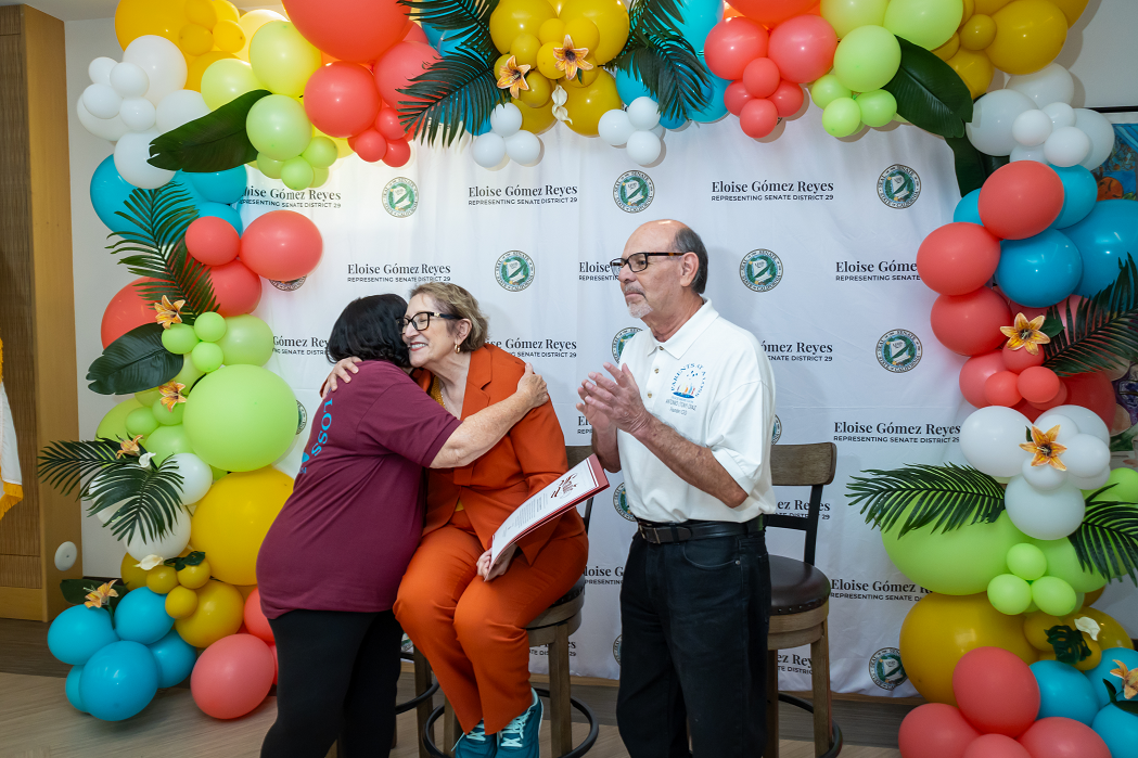 Senator Reyes congratulates an honoree with a hug